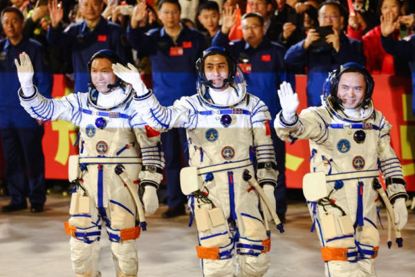 Shenzhou-21 space mission astronauts Zhang Lu (R), Zhang Hongzhang (L) and Wu Fei, greet the public during the seeing-off ceremony at the Jiuquan Satellite Launch Center near Jiuquan, China, Friday. Wu is China&#039;s youngest astronaut. Photo by Wu Hao/EPA