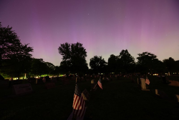 The Northern Lights pictured May 2024 over the American flags resting in a cemetery in Wadsworth, Ohio. NOAA officials stated this week&#039;s aurora does 